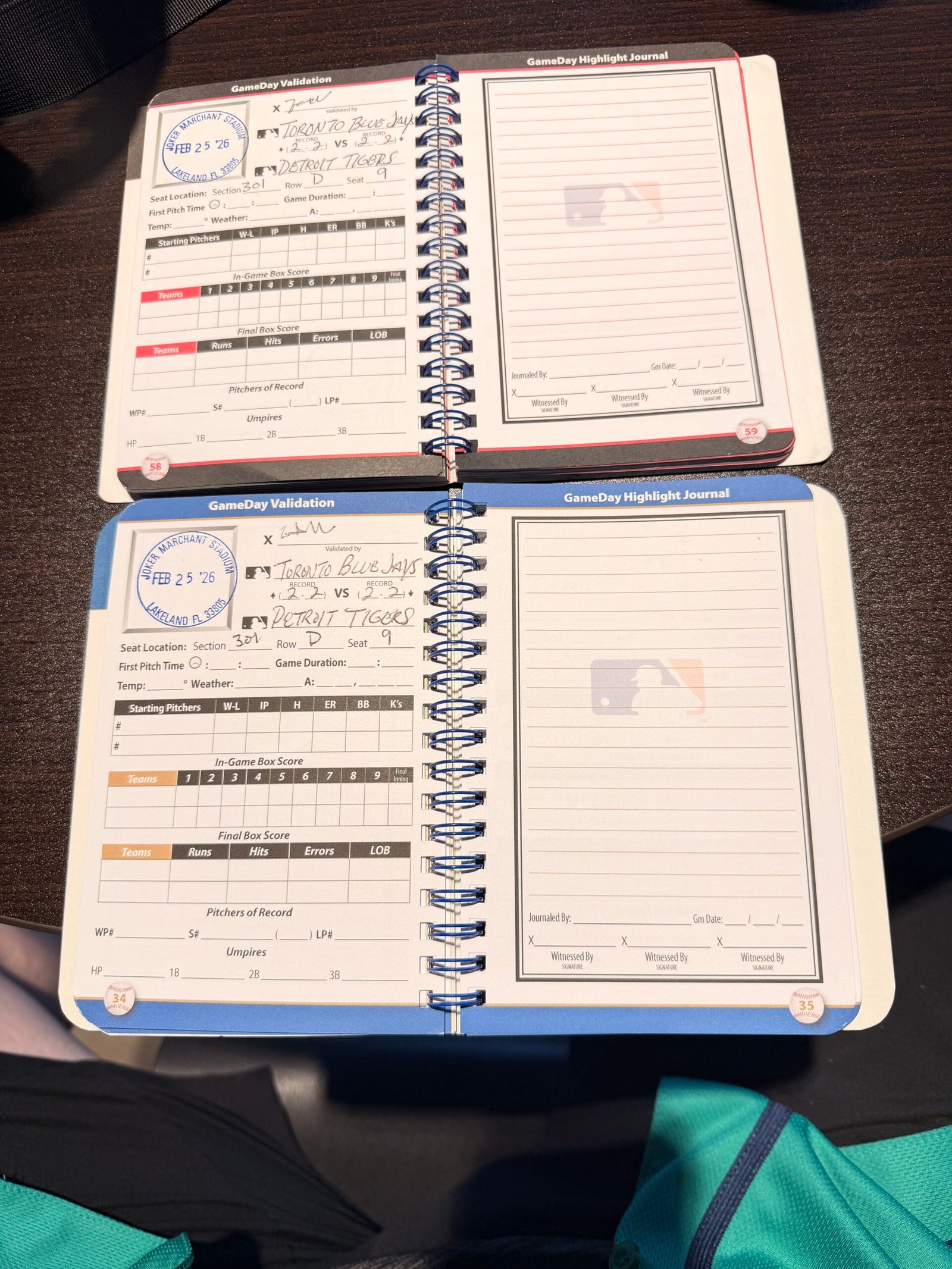 GameDay Passport scorebooks showing Joker Marchant Stadium stamp dated Feb 25 2026 for Toronto Blue Jays vs Detroit Tigers