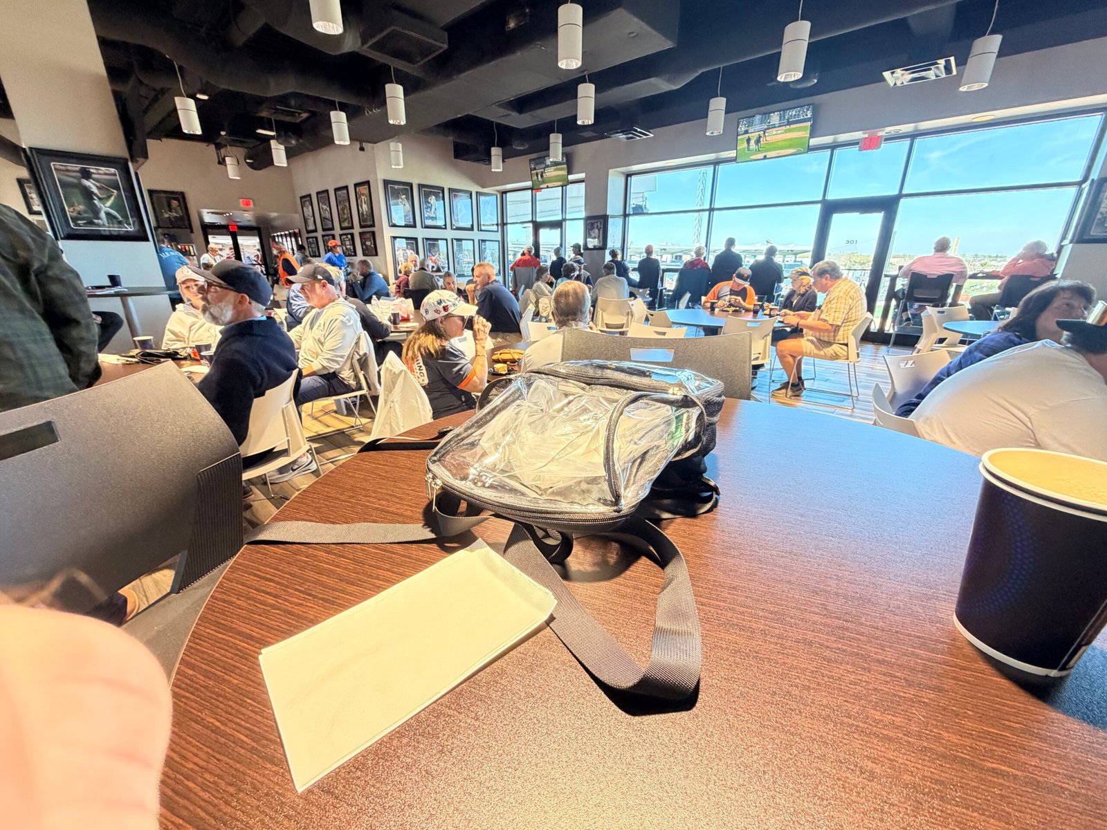 Inside the 34 Club at Joker Marchant Stadium showing dining area, memorabilia walls, and field windows