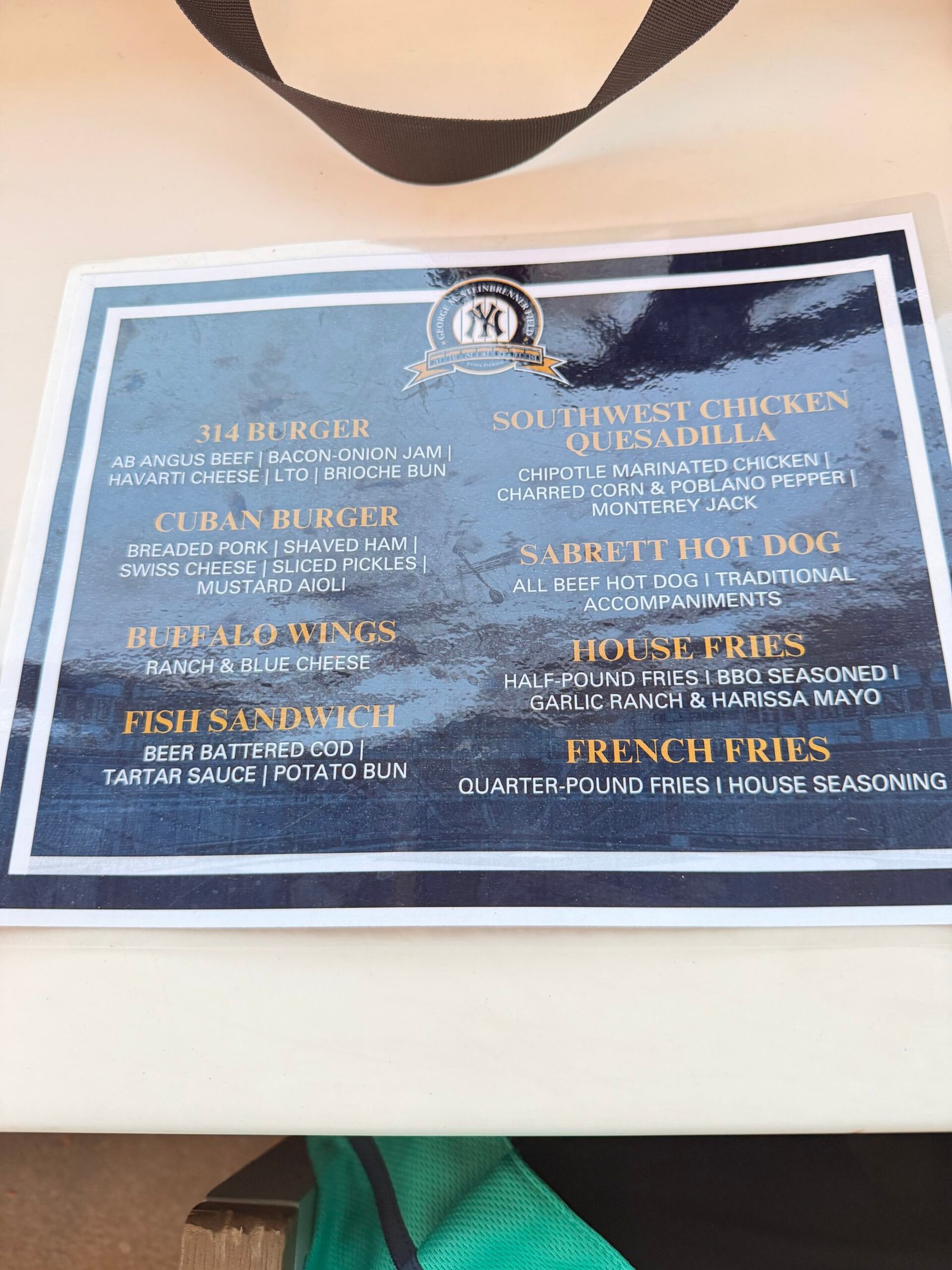 Steinbrenner Field club menu featuring the 314 Burger, Cuban Burger and Fish Sandwich